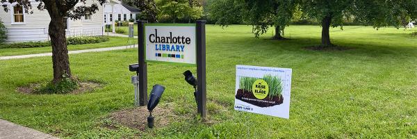 The Charlotte Library in Vermont has endorsed the Raise the Blade campaign and keeps its grass three inches or longer. Photo: Charlotte Library Charlotte Library sign, lawn and Raise the Blade sign